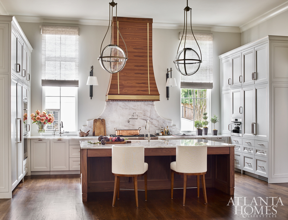 kitchen design winners marble island with wood range hood and round pendants over island