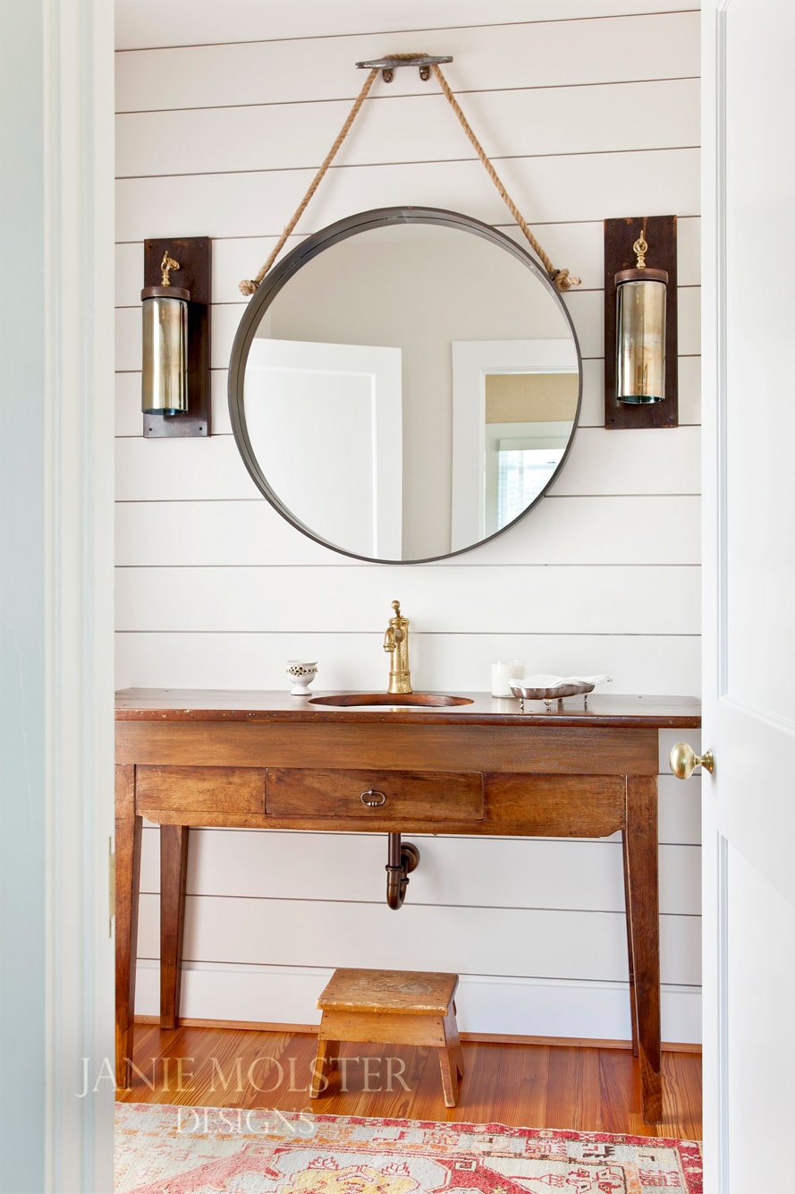 Fishing Bay bathroom with round mirror -Janie Molster Fishing Bay living room -So this stunning Fishing Bay house designed by Janie Molster (and Gordon Gregory Photography) seemed like a pretty fitting house to tour today. It's the perfect place to spend weekends for fishing right outside the door--and an equally fabulous place to curl up with a good book or get a little work done if you suddenly find yourself home alone during a grand fishing expedition. 