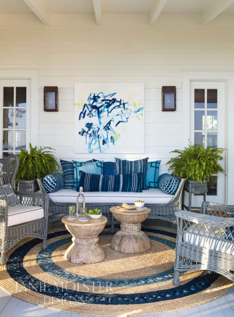  blue and white porch -Janie Molster Fishing Bay living room -So this stunning Fishing Bay house designed by Janie Molster (and Gordon Gregory Photography) seemed like a pretty fitting house to tour today. It's the perfect place to spend weekends for fishing right outside the door--and an equally fabulous place to curl up with a good book or get a little work done if you suddenly find yourself home alone during a grand fishing expedition. 