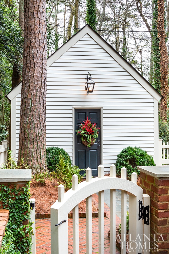 storage shedBeth Erin Designed Buckhead home curb appeal white brickAtlanta Homes & Lifestyles Beth Ervin Interior Design Norman Askins Architect Jeff Herr Photography Jonathan Bussell Landscape Design 