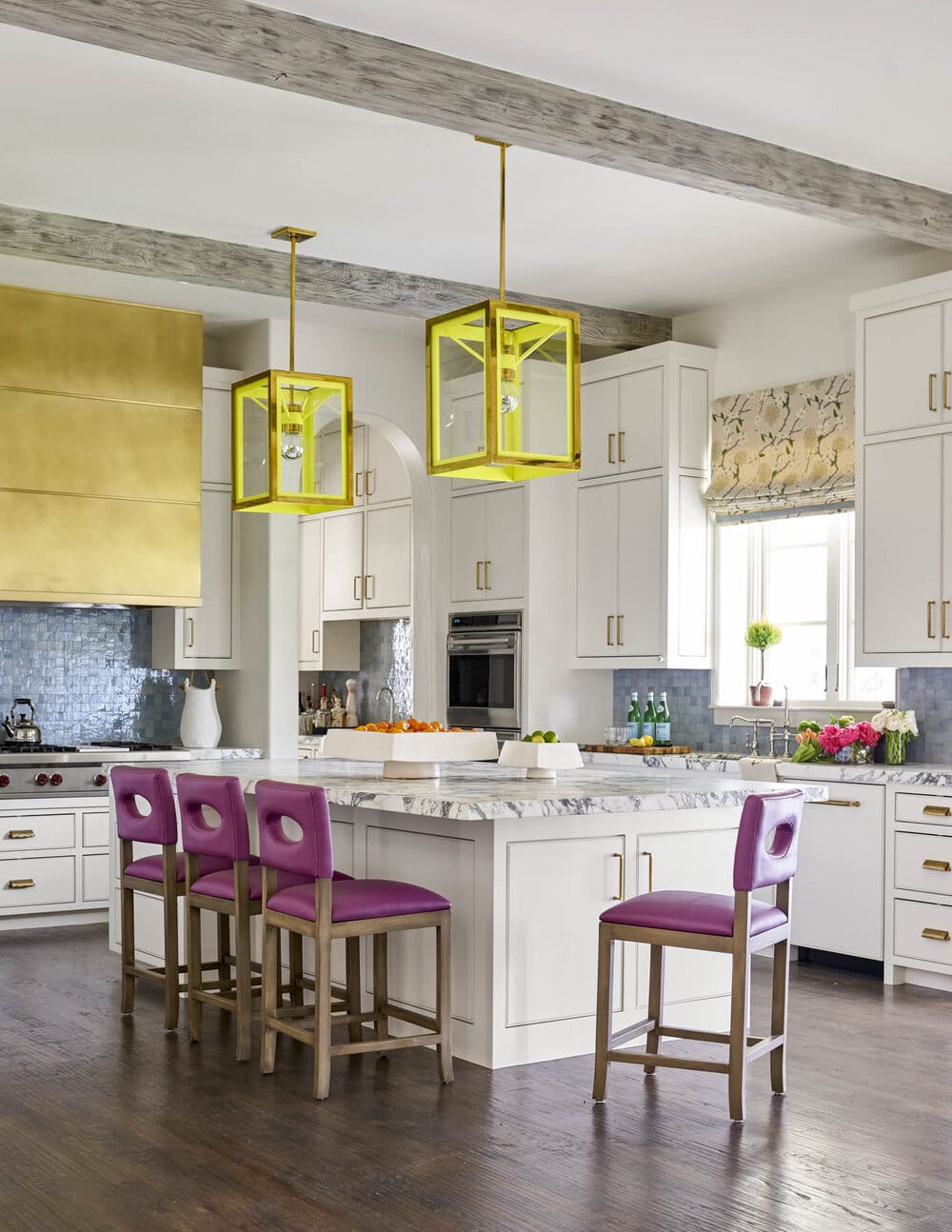 Delightful Dallas home from Designer Mary Beth Williams | Photography Nathan Schroder. Love the kitchen with the brass range hood and colorful lanterns and stools that are the perfect juxtaposition to the wood beams.