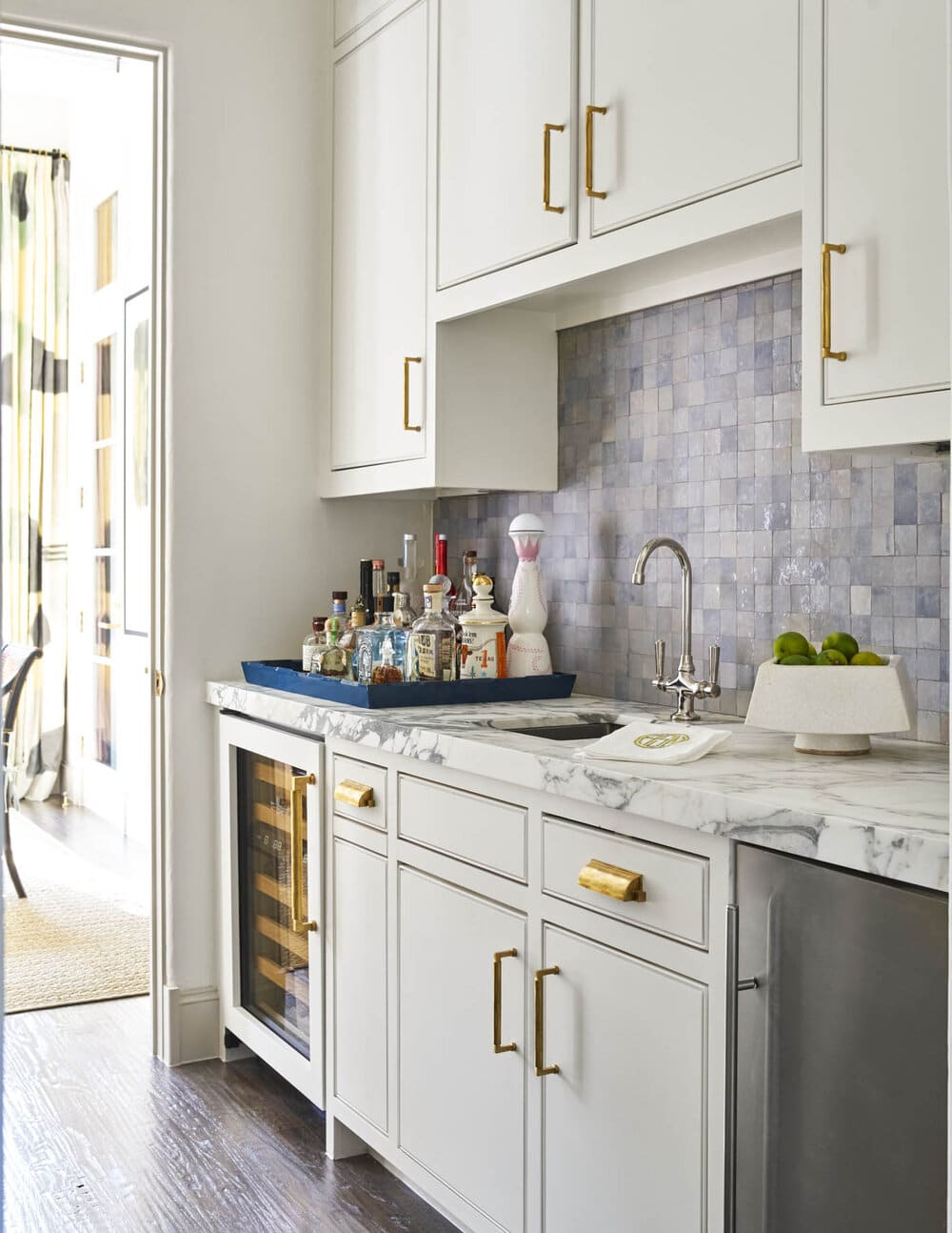 Delightful Dallas home from Designer Mary Beth Williams | Photography Nathan Schroder. Love the kitchen with the chrome fixtures and gorgeous marble countertops and wet bar