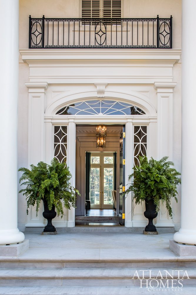 Source: Atlanta Homes & Lifestyles | Architect: C. Brandon Ingram | Interior Design: Mallory Mathison | Landscape Architect:  Carson McElheney | Photography:  Jeff Herr - extraordinary South Georgia home entry with black cast iron planters filled with ferns