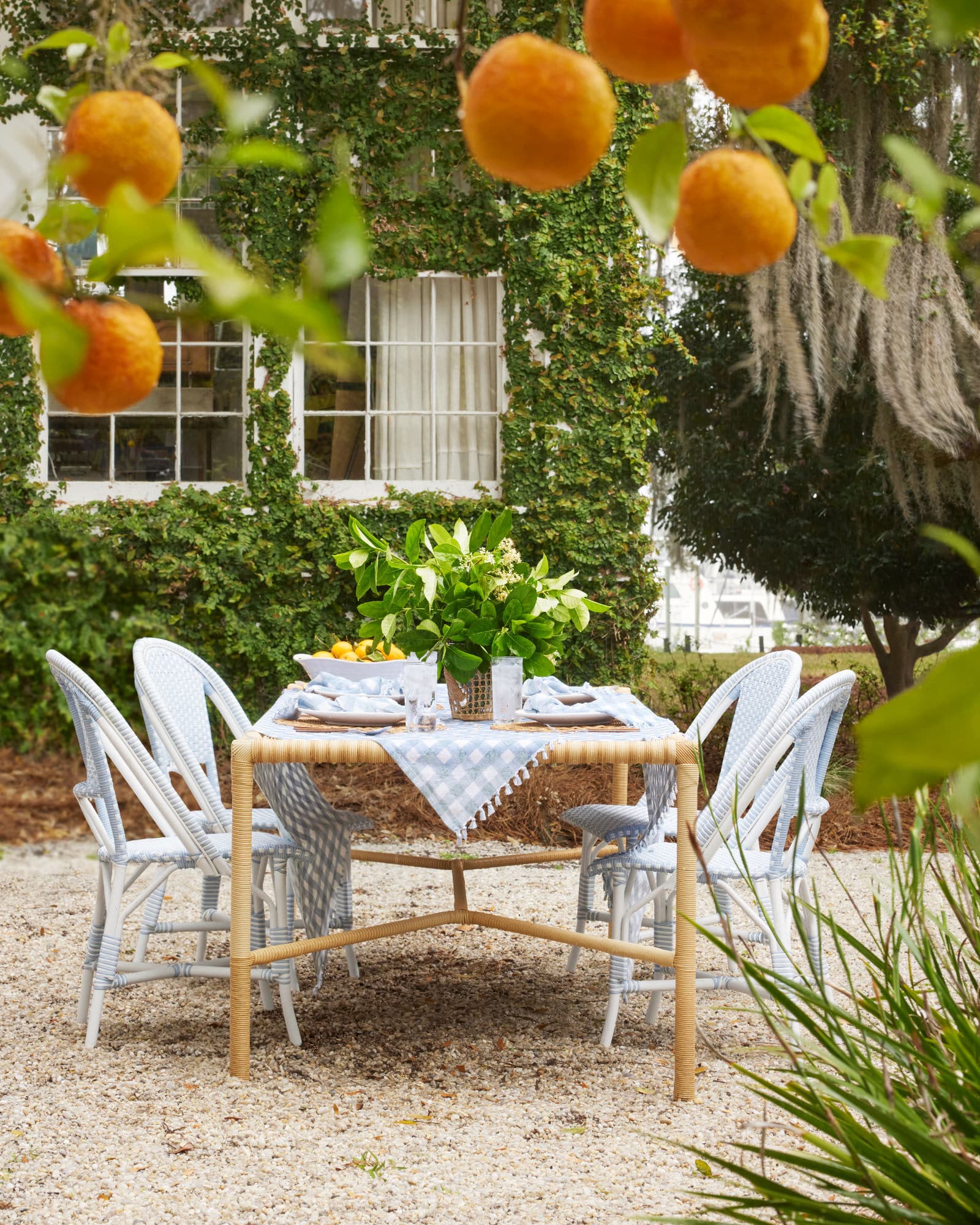 Dining al fresco - outdoor dining - porch - wicker table - pea gravel - Serena & Lily