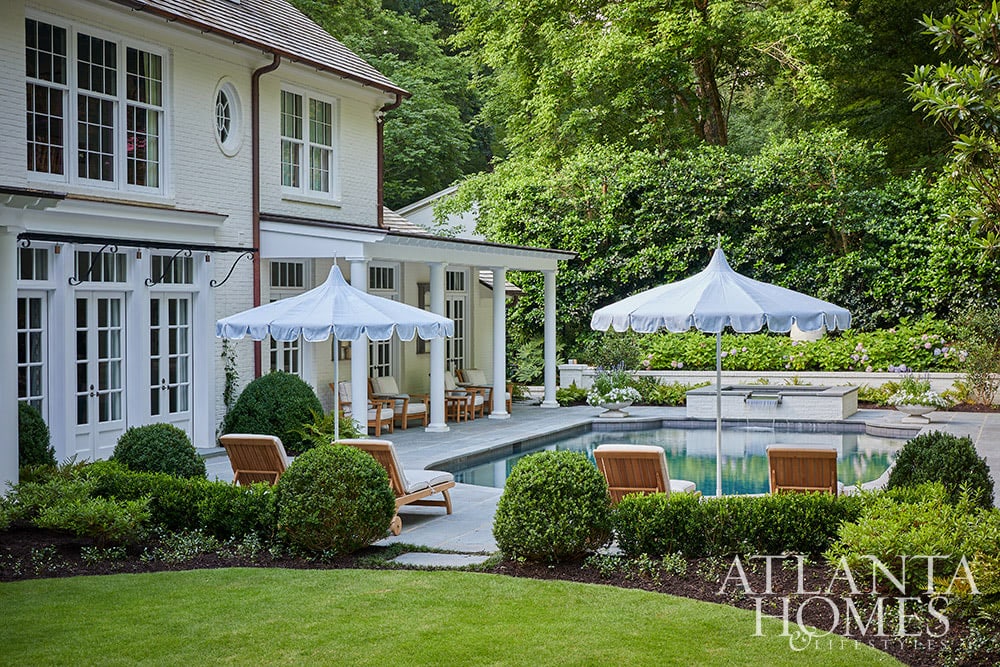 If you love English cottage style homes, then you'll want to take a tour of this 1950's Buckhead home  From the exposed beams in the living room to the delightful built-in reading nook, it is full of charming details. Beautiful white 2 story home with dormers Source: Atlanta Homes & Lifestyles Interior Design: Lanier Interiors Architect: Steve Fintak of D Stanley Dixon Architect Photography: Emily Followill Landscape Architect: Jonathan Bussell Builder: Smith Built Homes