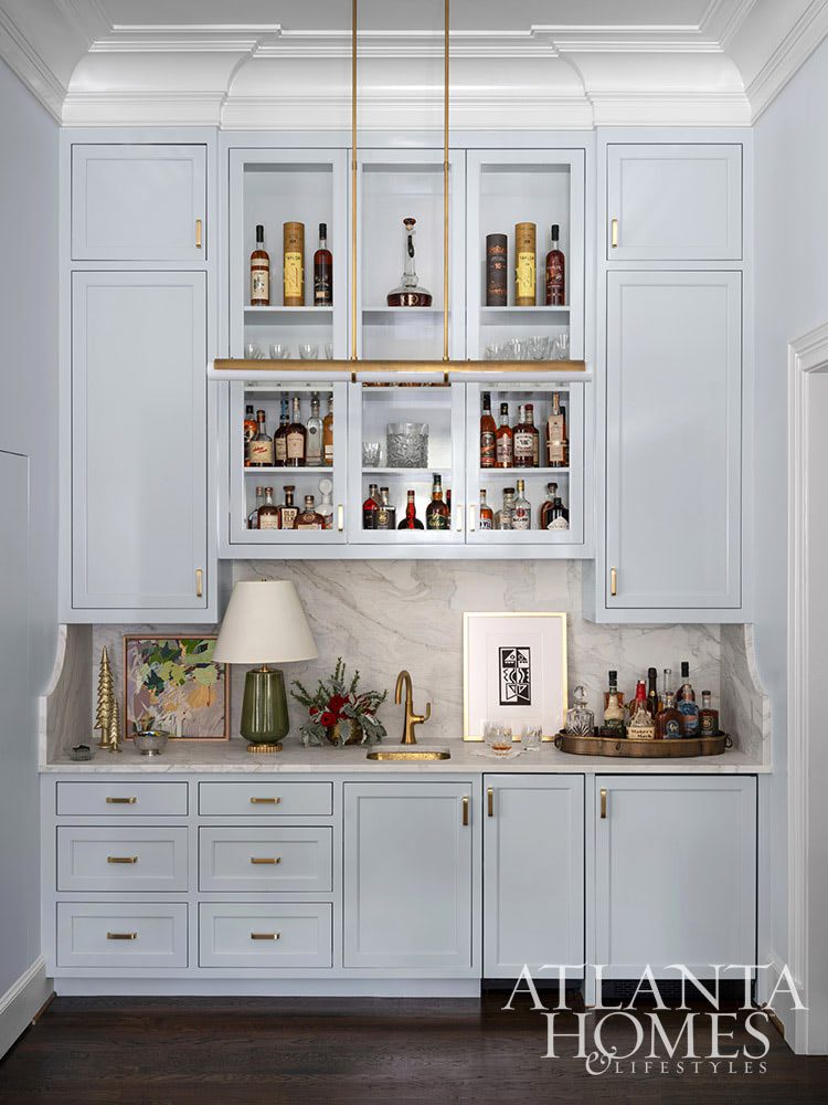 Deck the halls , wet bar, brass lighting, blue cabinets Source: Atlanta Homes & Lifestyle Architect Ross Piper Builder Stuart Grubb Interior Designer Sande Beck Photographer Rustic White Photography