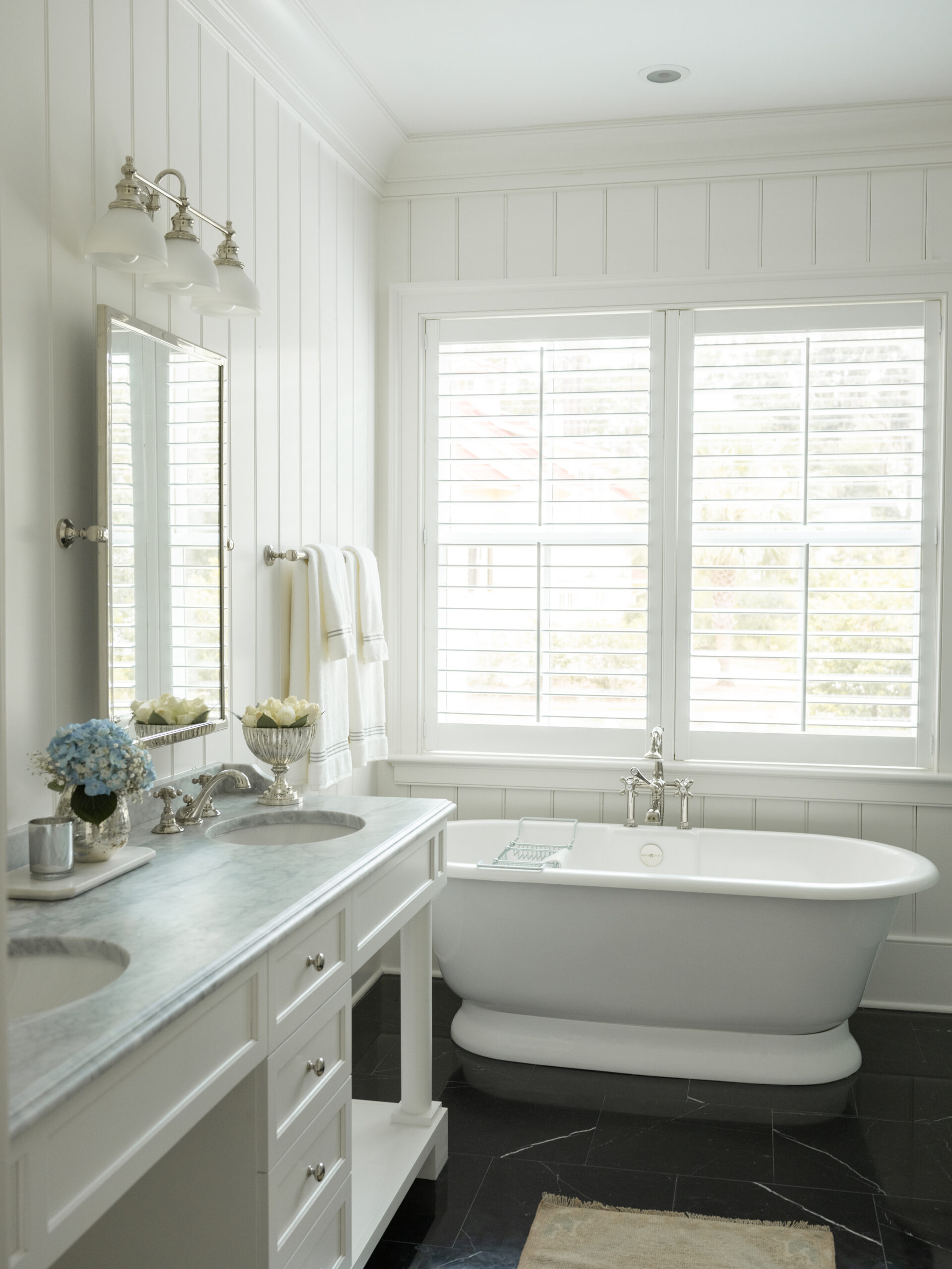Life–and houses–are all about the details. And no one embraces that philosophy better than Leah Bailey Interiors . From the largest room to the tiniest nook, nothing is overlooked. Kelli Boyd Photography - beautiful white bathroom with shiplap on the walls and a freestanding tub