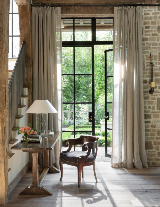 Stunning living room with steel French doors with a desk and chair perfect for a home office -Tradition Made New soulful houses