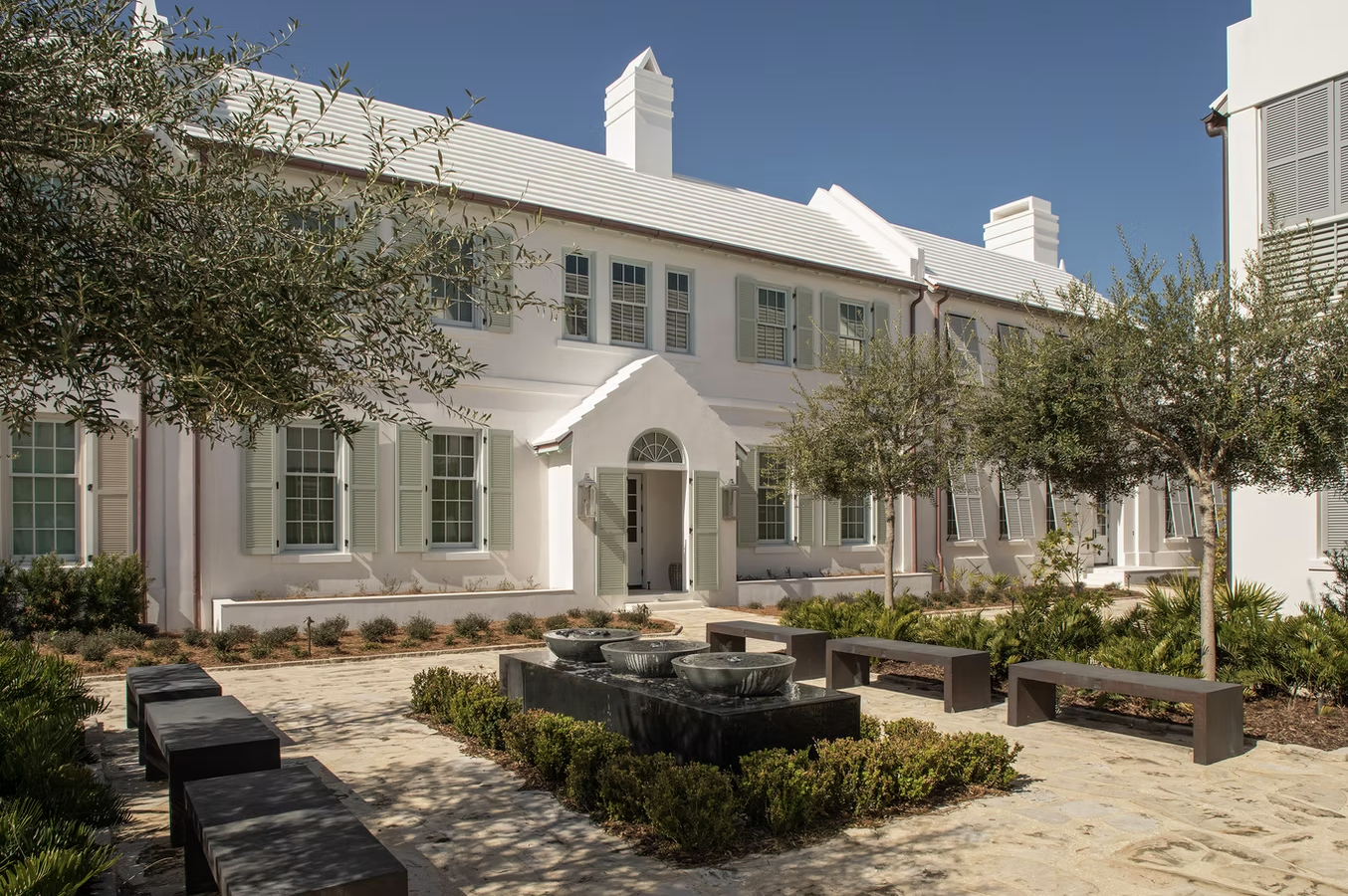  If you're in the mood for a vacation today, but can't leave town, don't worry! One peek at this stunning coastal home on Alys Beach designed by Brad Ramsey Interiors  and, you'll feel like you're a million miles away! Jack Gardner PHotography - white house with light green shutters