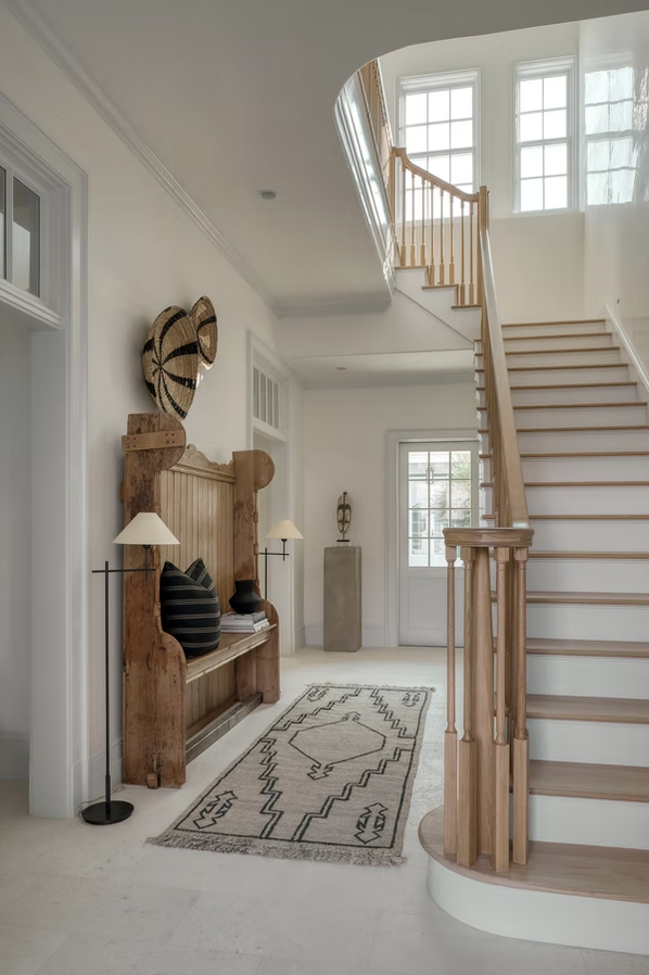 If you're in the mood for a vacation today, but can't leave town, don't worry! One peek at this stunning coastal home on Alys Beach designed by Brad Ramsey Interiors  and, you'll feel like you're a million miles away! Jack Gardner PHotography - Love the neutral entry with hanging baskets on the wall