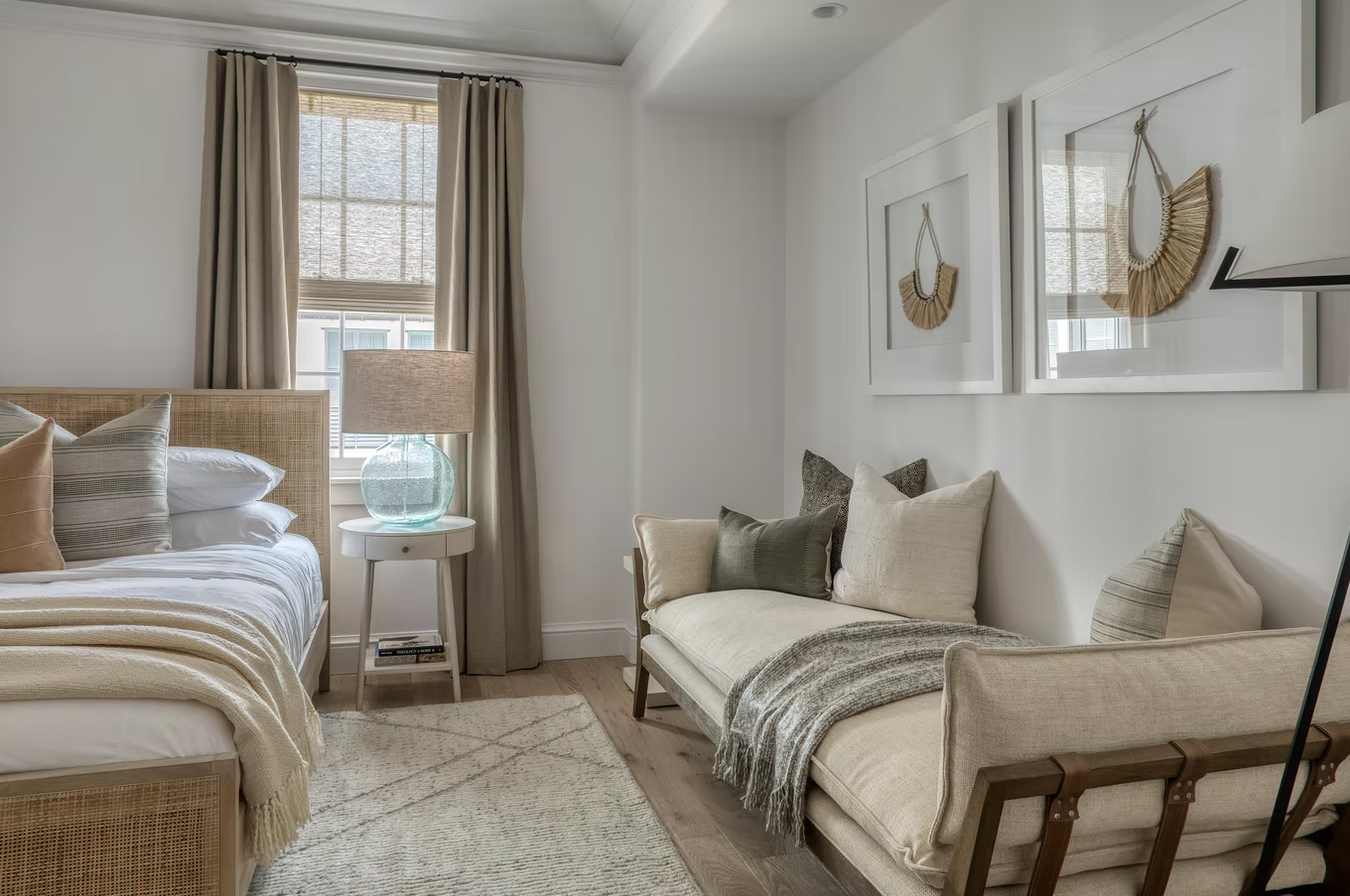 If you're in the mood for a vacation today, but can't leave this stunning coastal home in Alys Beach designed by Brad Ramsey Interiors makes you feel like you're a million miles away! Jack Gardner Photography - Beautiful primary bedroom in this coastal home with African artifacts