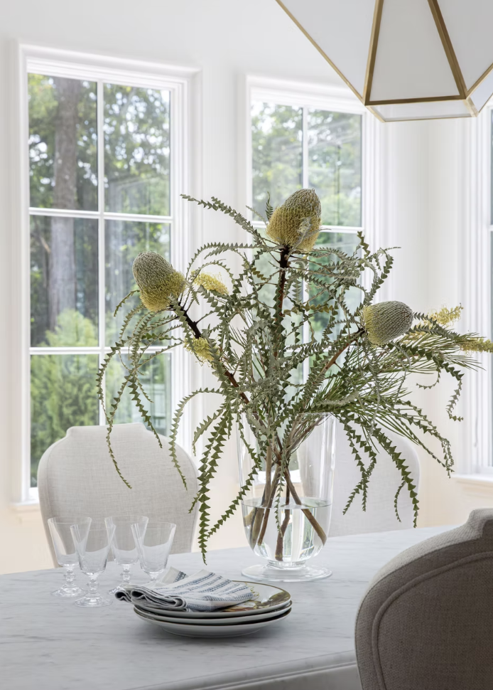 The centerpiece of flowers on this dining room table is simple and elegant