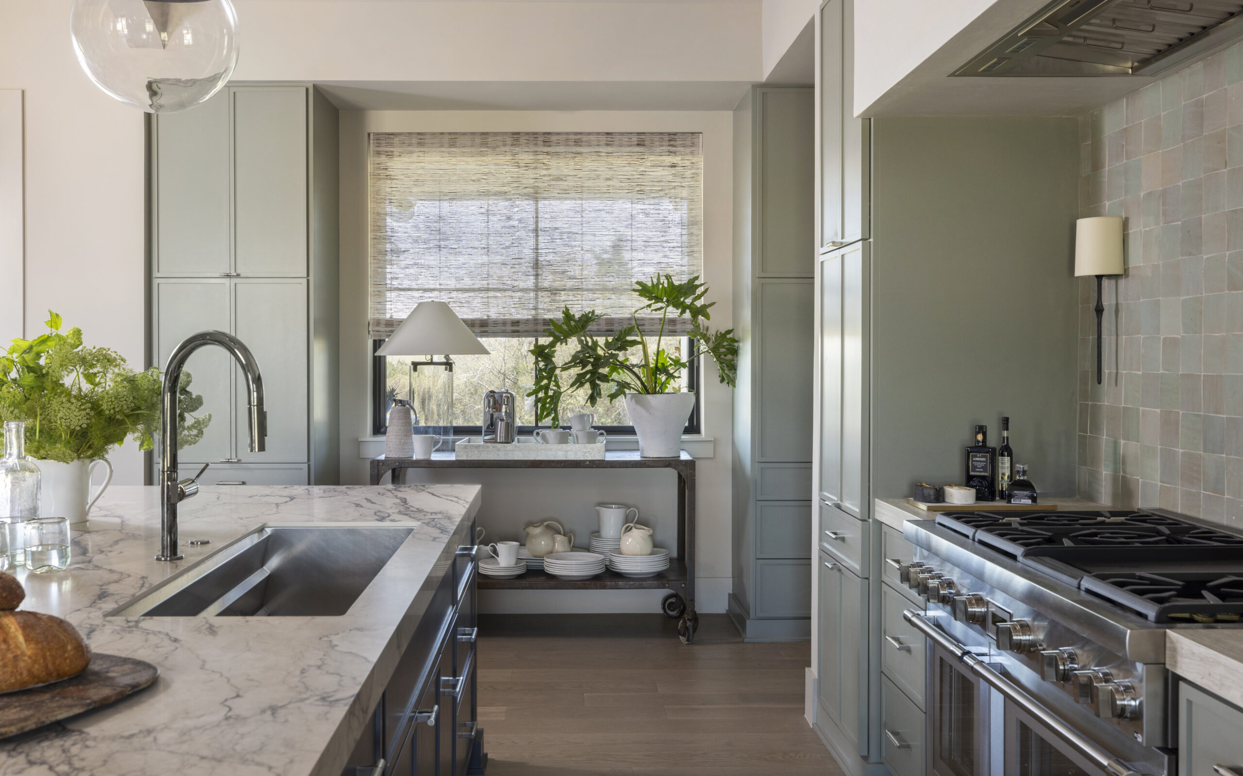 Modern kitchen design from Round Top Designer Showhouse with sleek countertops and warm lighting -photography by Julie Soefer 